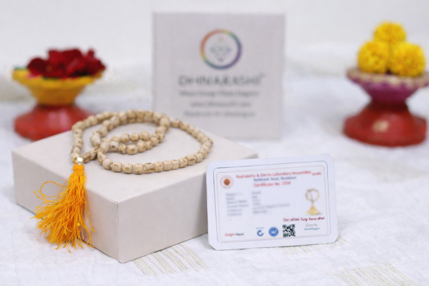 Dhivarashi Tulsi wood mala necklace with natural wooden beads and saffron tassel displayed with branded box and information card