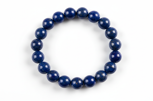 Create a premium product image of a **Lapis Lazuli Wisdom Bracelet** made with natural deep-blue lapis lazuli beads. Arrange the bracelet neatly in a circular shape on a clean white background with soft shadows. Highlight the rich blue stone texture and its third-eye intuition and spiritual awareness energy. 1:1 square image.
