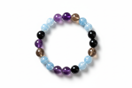 Create a premium product image of a **Natural Protection Crystal Bracelet** featuring Amethyst, Smoky Quartz, Blue Lace Agate, and Black Tourmaline beads. Arrange the bracelet neatly in a clear circular shape on a clean white background with soft shadows. Highlight the rich crystal colors and strong Shani Raksha protective energy. 1:1 square image.
