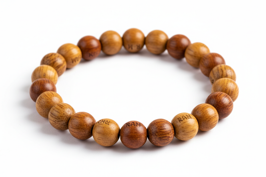Create a premium product image of a **Ram Name Tulsi Bracelet** made with natural Sumanni (holy basil) wood beads. Arrange the bracelet neatly in a circular shape on a clean white background with soft shadows. Highlight the sacred Tulsi wood texture and devotional Hindu spiritual energy. 1:1 square image.
