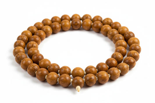 Create a premium product image of a **Tulsi Kanthi Mala** made from natural holy basil wood beads. Arrange the mala neatly in a circular shape on a clean white background with soft shadows. Highlight the sacred Tulsi wood texture and Krishna devotion spiritual energy. 1:1 square image.
