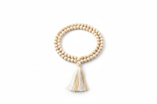 Create a premium product image of a **White Chandan Mala 6mm** with natural sandalwood small beads and a tassel. Arrange the mala neatly in a clear circular shape on a clean white background with soft shadows. Highlight the light wood texture and calm spiritual meditation energy. 1:1 square image.
