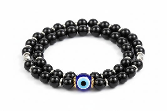 Create a premium product image of an **Evil Eye Onyx Protection Bracelet** made with black onyx, hematite beads, and a central evil eye bead. Arrange the bracelet neatly in a circular shape on a clean white background with soft shadows. Highlight the glossy black stones and strong negative-energy protection shield. 1:1 square image.
