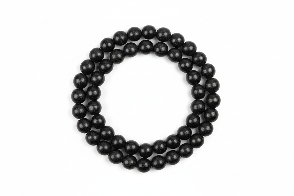 Create a premium studio-quality image of a **Karungali Mala 8mm** made with natural ebony wood black beads. Arrange the mala neatly on a clean white background with soft shadows. Make the beads look polished, rich, and authentic, highlighting spiritual protection and meditation energy. Keep the style minimal, elegant, and perfect for an online store product photo. 1:1 square image.
