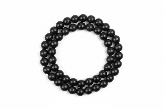 Create a premium studio-quality image of a **Karungali Mala 8mm** made with natural ebony wood black beads. Arrange the mala neatly on a clean white background with soft shadows. Make the beads look polished, rich, and authentic, highlighting spiritual protection and meditation energy. Keep the style minimal, elegant, and perfect for an online store product photo. 1:1 square image.
