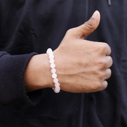 Dhivarashi rose quartz bracelet worn by men with natural pink gemstone beads, suitable for unisex daily wear and associated with confidence, calmness, emotional balance and positive energy. Buy online at https://dhivarashi.com/products/dhivarashi-rose-quartz-bracelet-daily-wear-hand-unisex