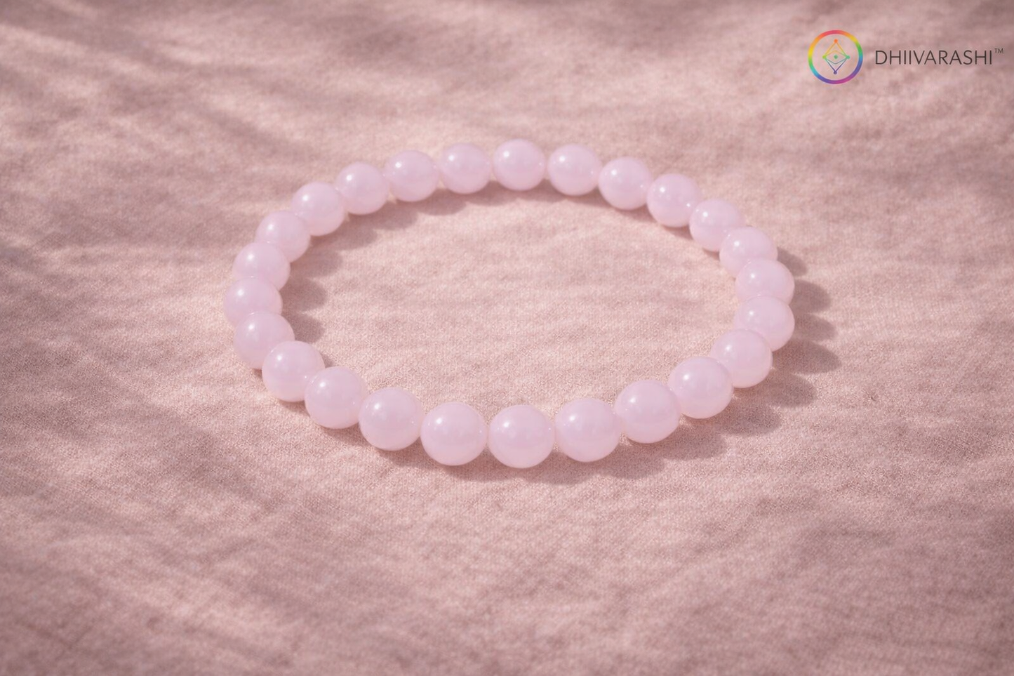 DHIVARASHI rose quartz healing crystal bracelet placed on soft surface, natural pink gemstone bracelet for heart chakra calmness love and emotional healing