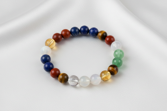 natural crystal bracelet made with Lapis Lazuli, Sunstone, Red Jasper, Citrine, Green Aventurine, Moonstone, Tiger Eye, Clear Quartz, Pyrite.On white silk cloth with no shadow