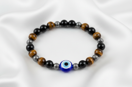 natural crystal bracelet made with Tiger Eye, Black Obsidian, Hematite, Evil Eye bead.On white silk cloth with no shadow