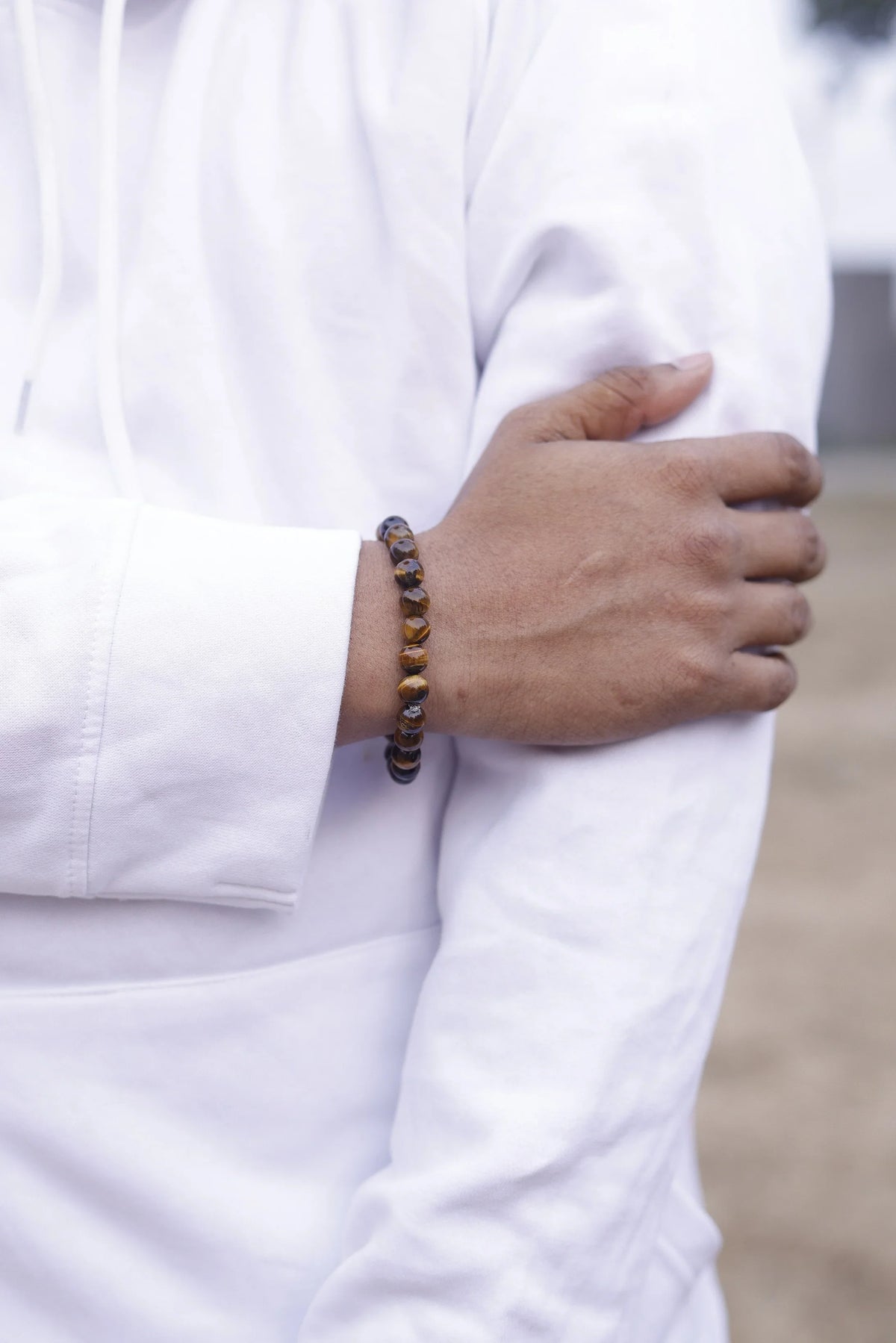 https://dhivarashi.com/cdn/shop/files/tiger-eye-confidence-bracelet-men-wearing-lifestyle.jpg?v=1768990664&width=1946
